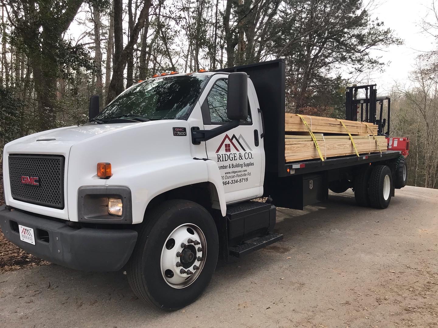 Ridge & Co. flatbed truck loaded with treated lumber for delivery