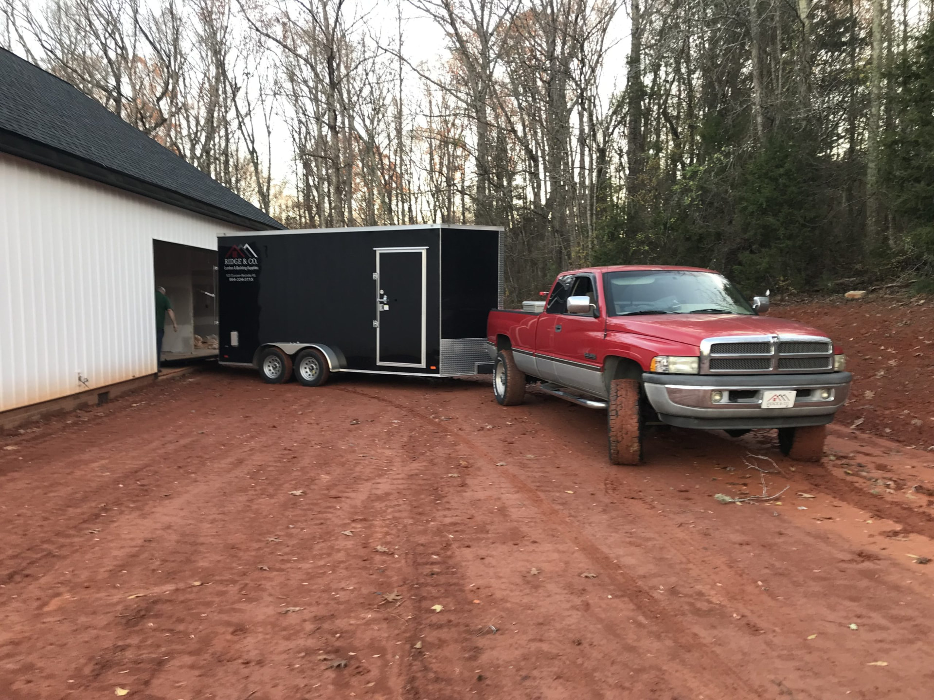 Ridge & Co. enclosed trailer and truck at a residential jobsite